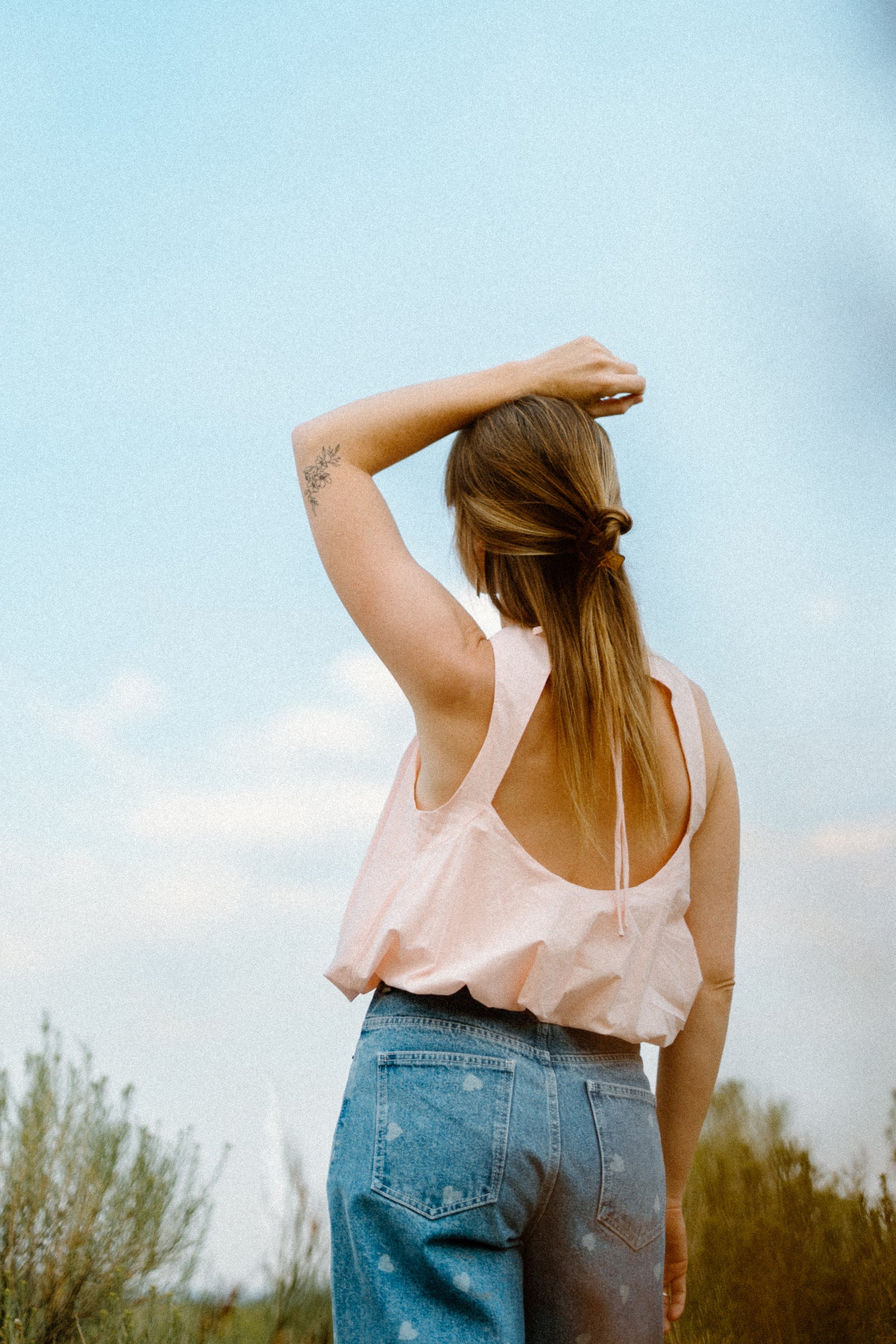 Woman standing outside with a temporary tattoo on her arm